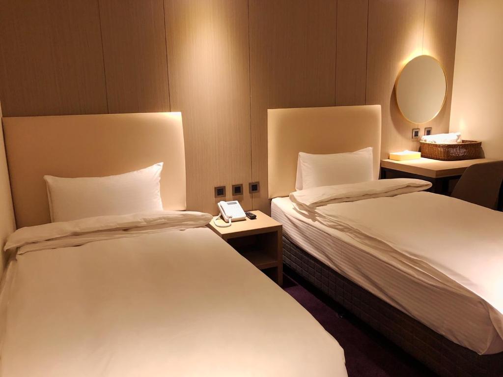 Postel nebo postele na pokoji v ubytování Michi Hotel - Luodong