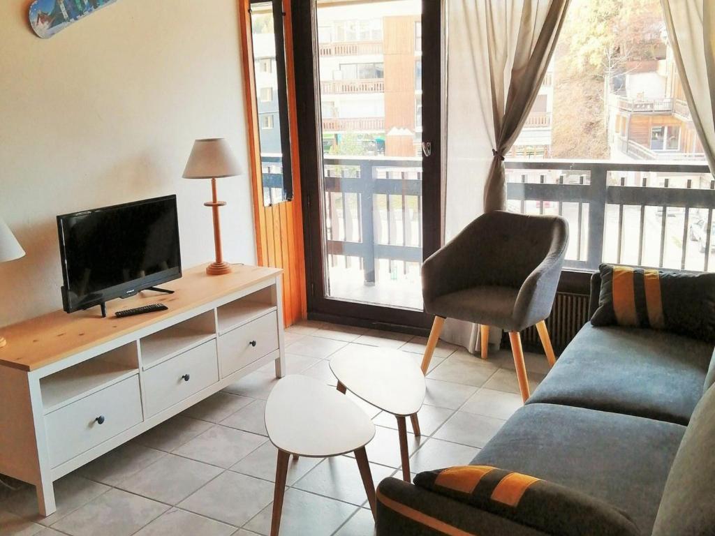 a living room with a couch and a tv at Appartement Les Deux Alpes, 2 pièces, 6 personnes - FR-1-516-161 in Les Deux Alpes