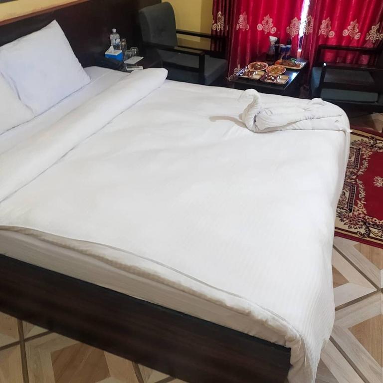 Postel nebo postele na pokoji v ubytování New sunlight Hotel