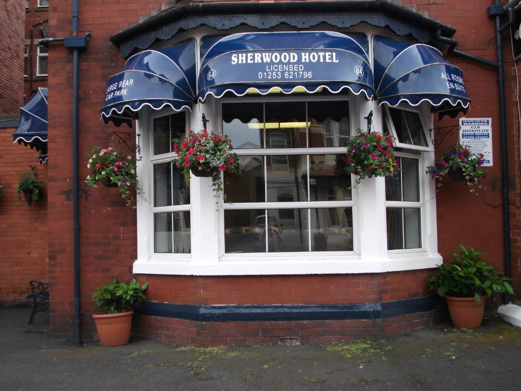 a building with a window with flowers and an awning at Sherwood Hotel in Blackpool