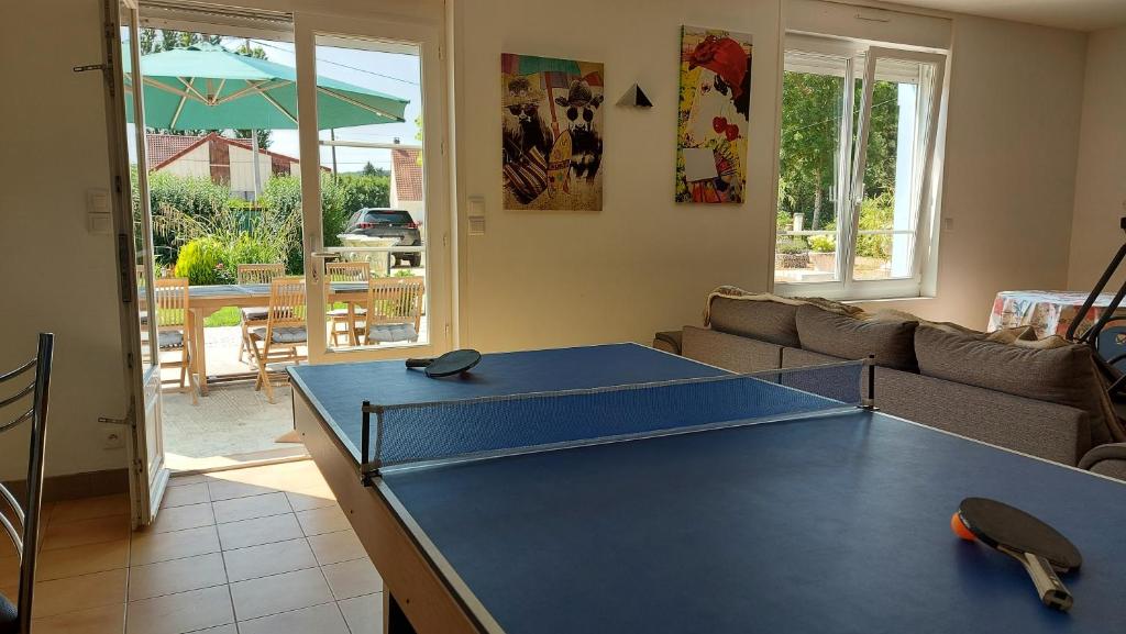 a blue ping pong table in a living room at Le Moulin de la Planquette in Cavron-Saint-Martin