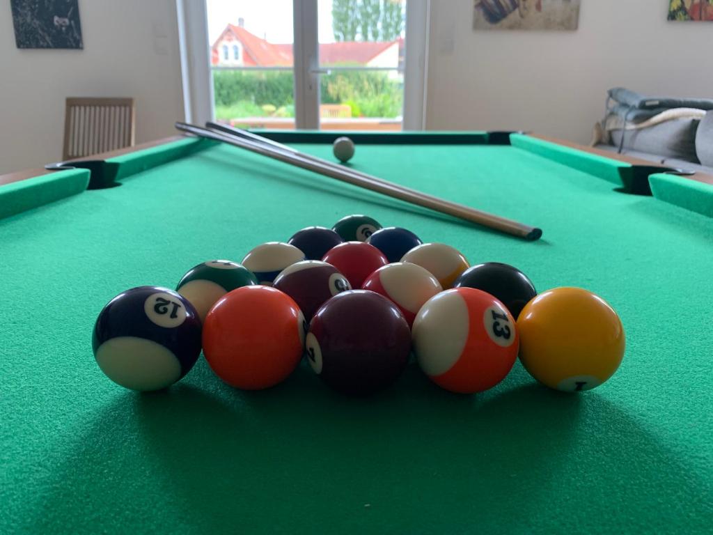 a group of billiard balls on a pool table at Le Moulin de la Planquette in Cavron-Saint-Martin