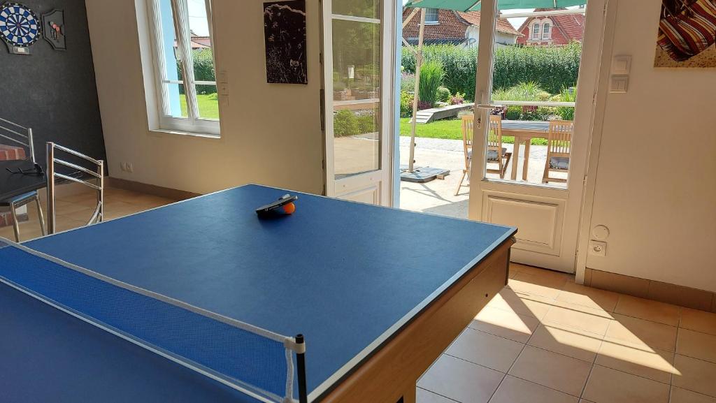 a ping pong table in a room with a ping pong ball at Le Moulin de la Planquette in Cavron-Saint-Martin