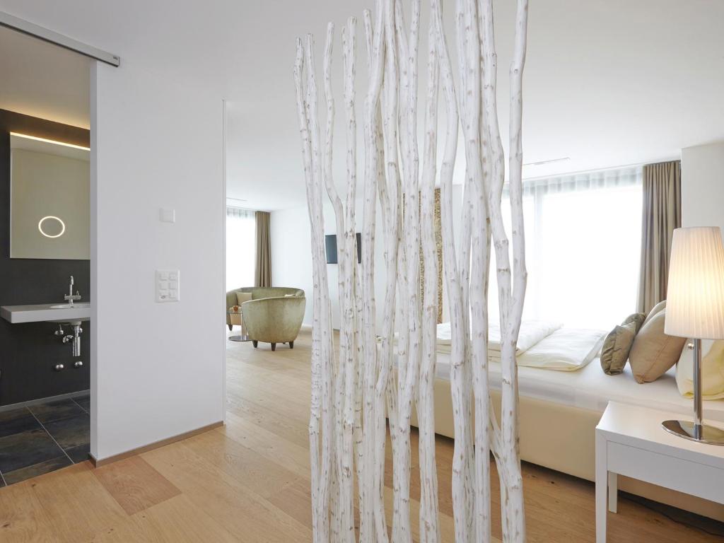 a hotel room with a bed and a mirror at Hotel AVA in Sempach Station