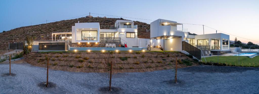 a large house in front of a mountain at Agia Pelagia Villas in Agia Pelagia