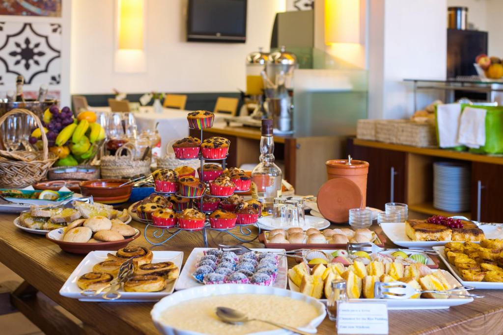 a table with many different types of food on it at Costa d'Oiro Ambiance Village in Lagos