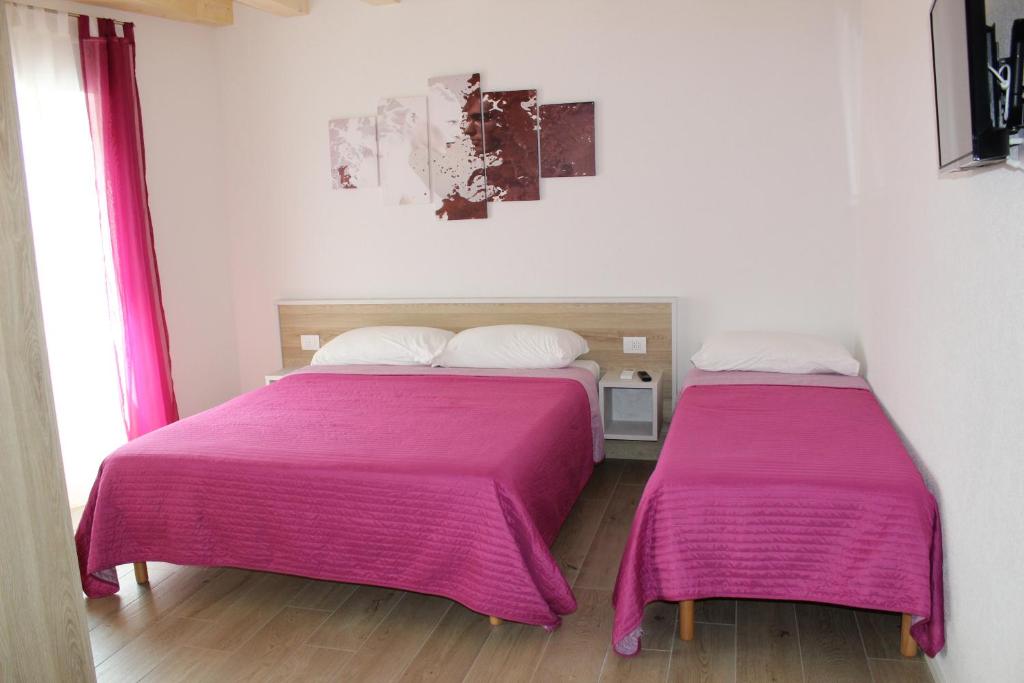 Postel nebo postele na pokoji v ubytování B&B Al Portico