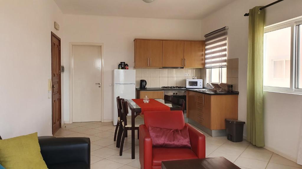 a kitchen with a table and chairs in a room at Santana single bedroom serviced apartment in Santa Maria