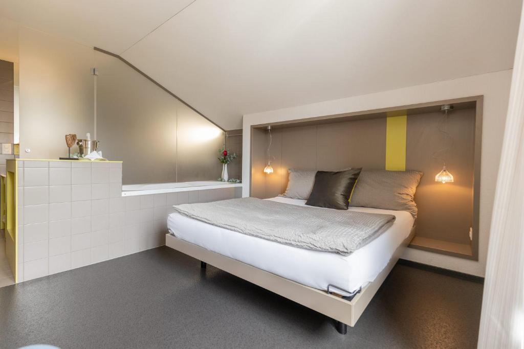 a bedroom with a large bed in a room at Hotel Restaurant Sternen in Gelfingen