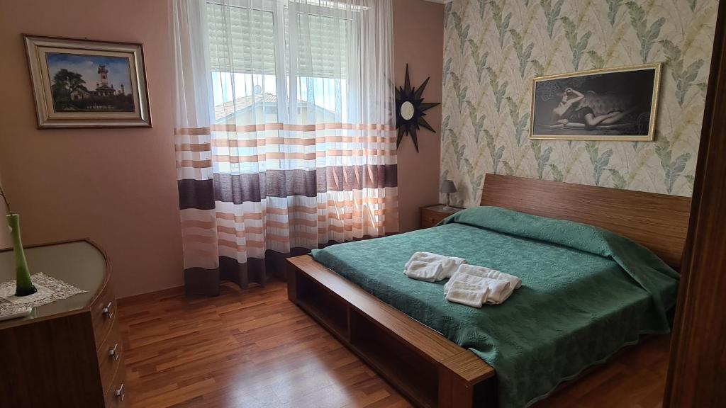 a bedroom with a bed with two towels on it at B&B Regina in Busto Arsizio