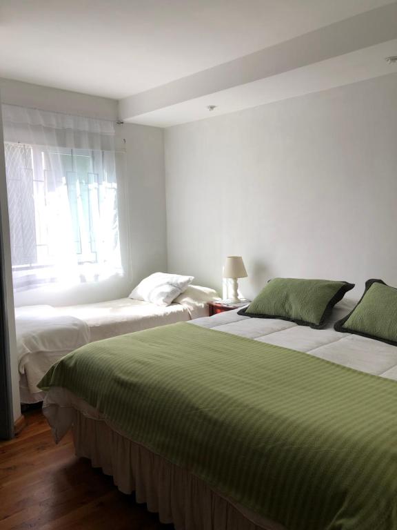 Postel nebo postele na pokoji v ubytování Hostal Magnolio