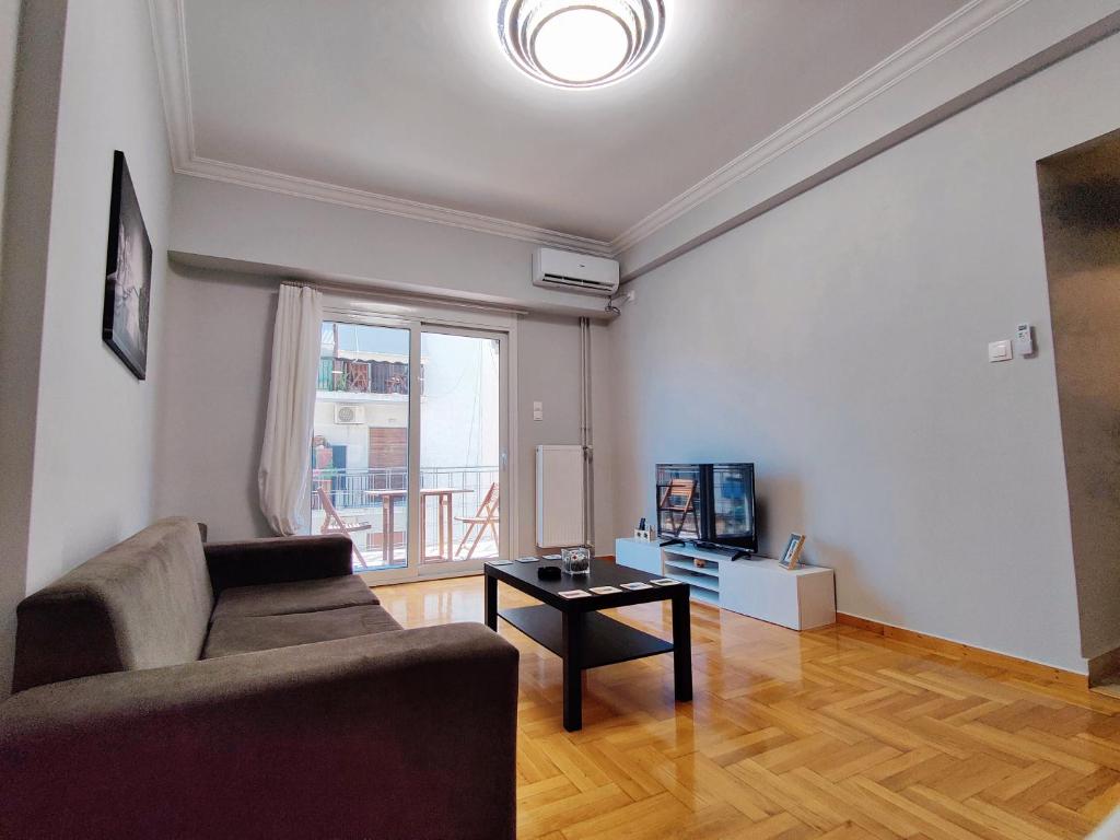 a living room with a couch and a table at WSD Brand Cozy 2BD with Balcony near Acropolis in Athens