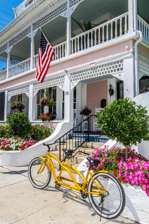 a yellow bike parked in front of a house with an american flag at The Kenwood Inn Oldest Bed and Breakfast, St Augustine Historic District in St. Augustine