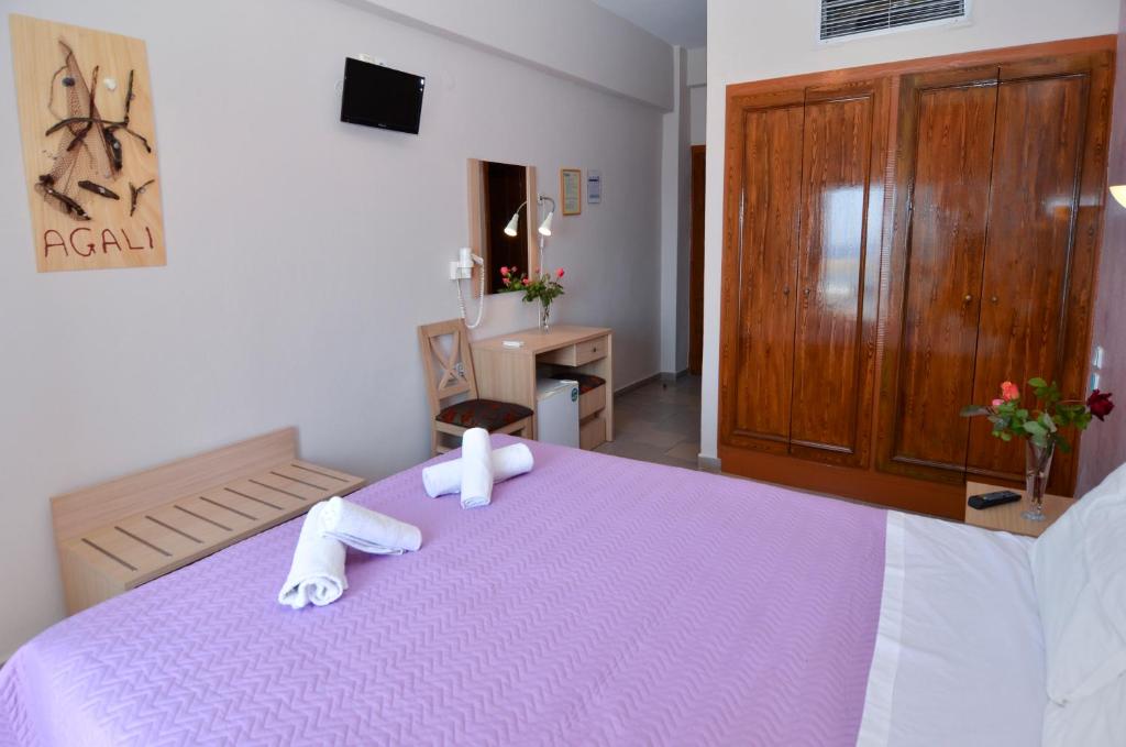 A bed or beds in a room at Agali Hotel