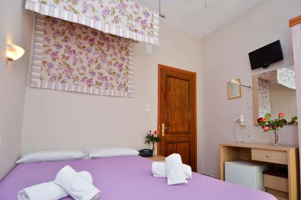 A bed or beds in a room at Agali Hotel