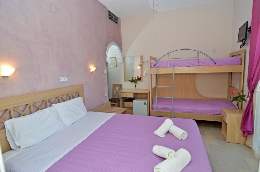 A bed or beds in a room at Agali Hotel