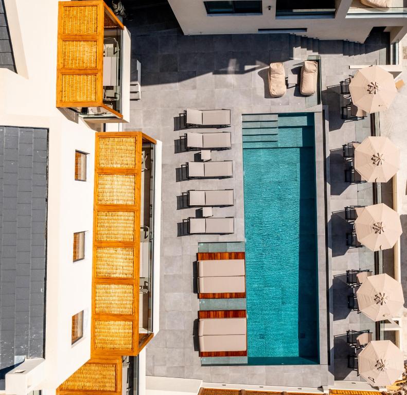 an aerial view of a building with a swimming pool at Elivia Boutique Suites in Almiropótamos