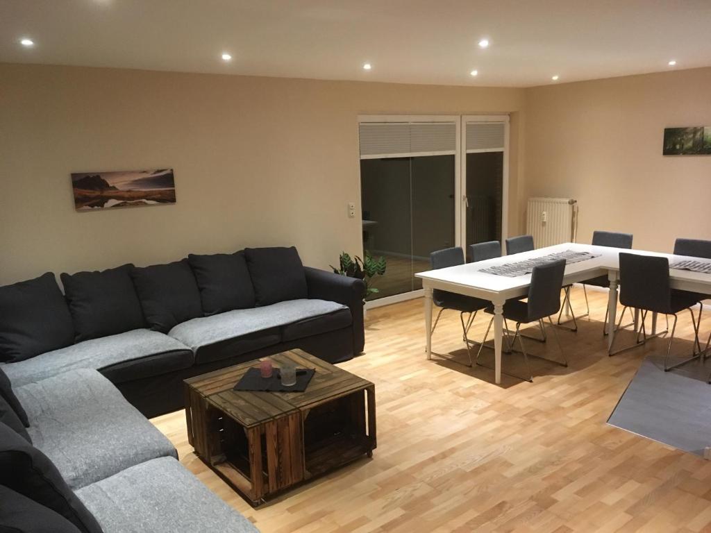 a living room with a couch and a table at Landhaus von Frieling - Neuenkirchen in Neuenkirchen