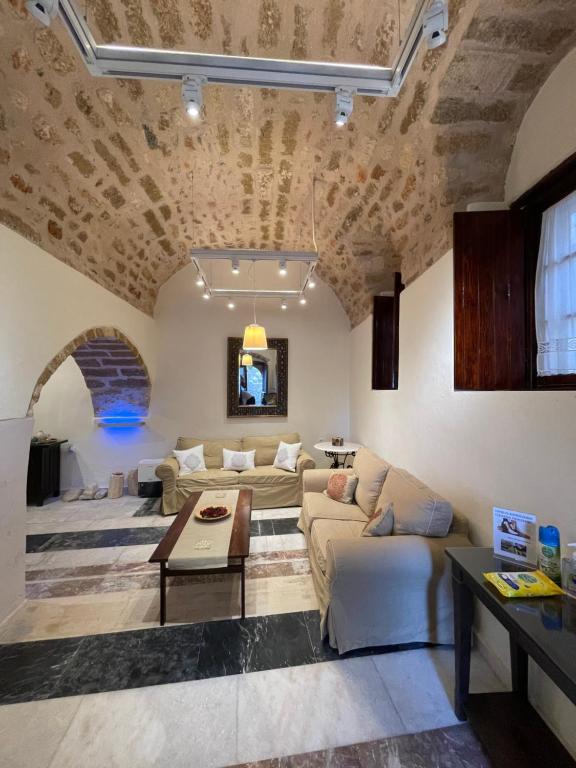 a living room with a couch and a table at Astrolithos Castle in Monemvasia