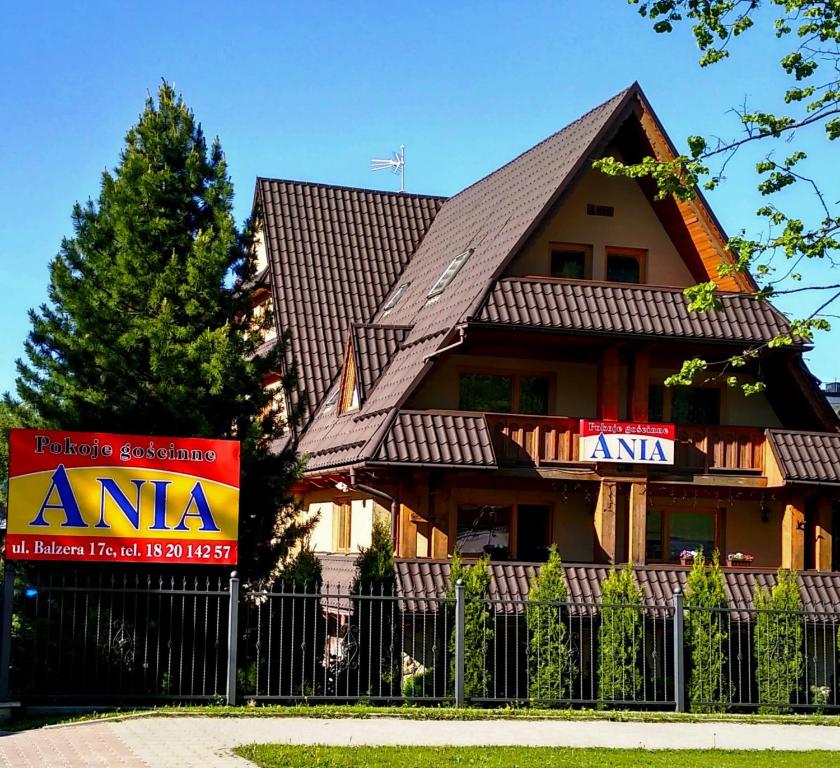 a house with a sign in front of it at Ania Wynajem Pokoi in Zakopane