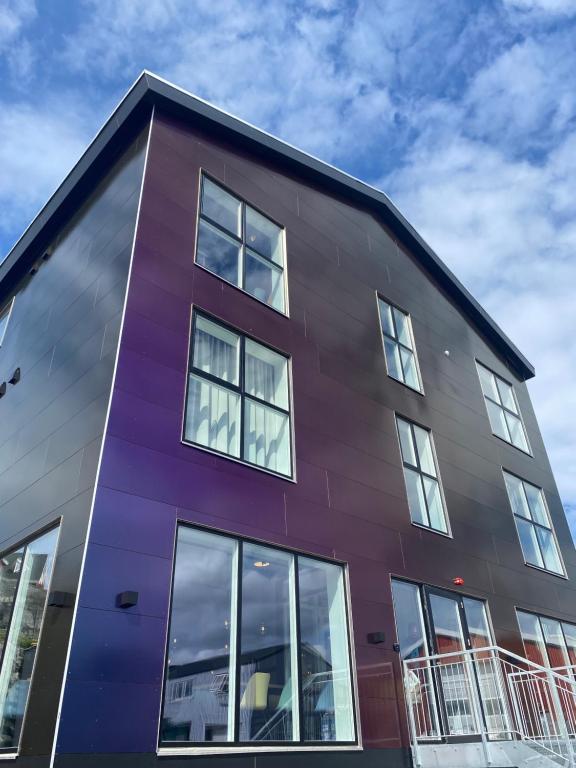 a purple building with windows at Hotel Aurora in Nuuk