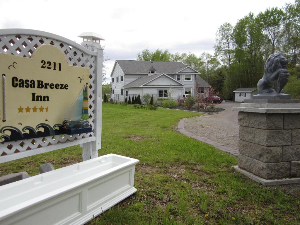 a sign for the cason bee inn with a statue at Casa Breeze B & B in Saint Stephen