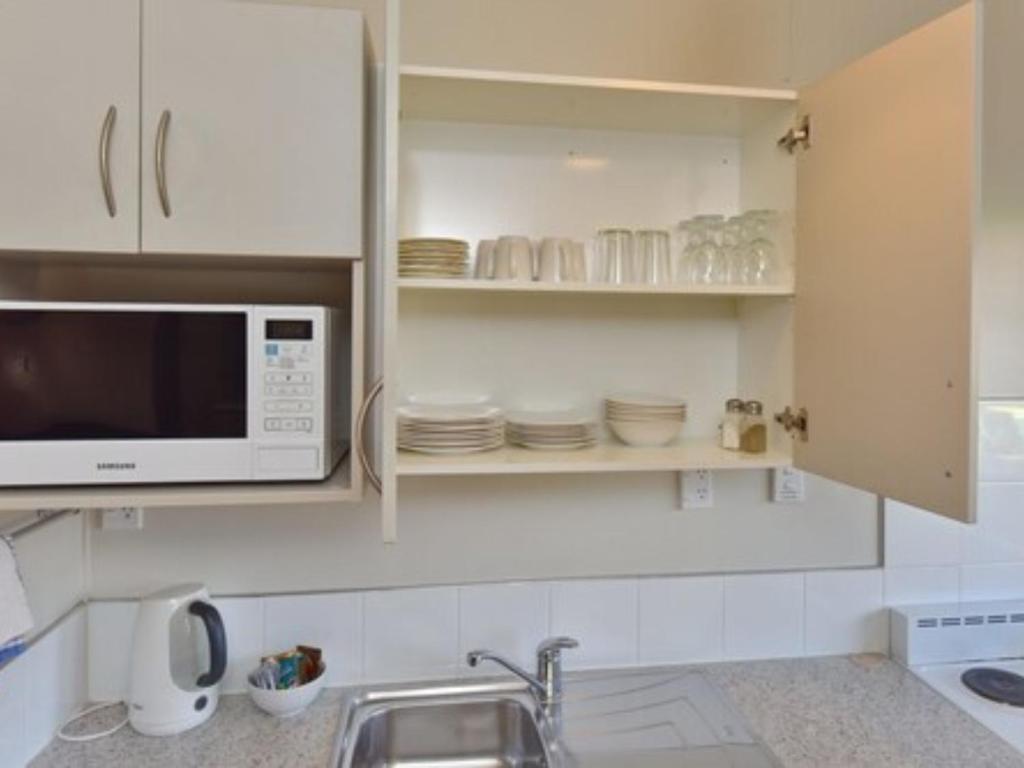 Kuchyň nebo kuchyňský kout v ubytování Northcote Motor Lodge