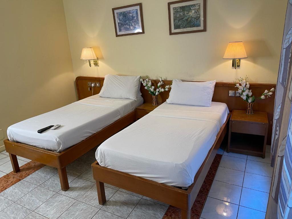 Postel nebo postele na pokoji v ubytování Maple Leaf Korean Hotel