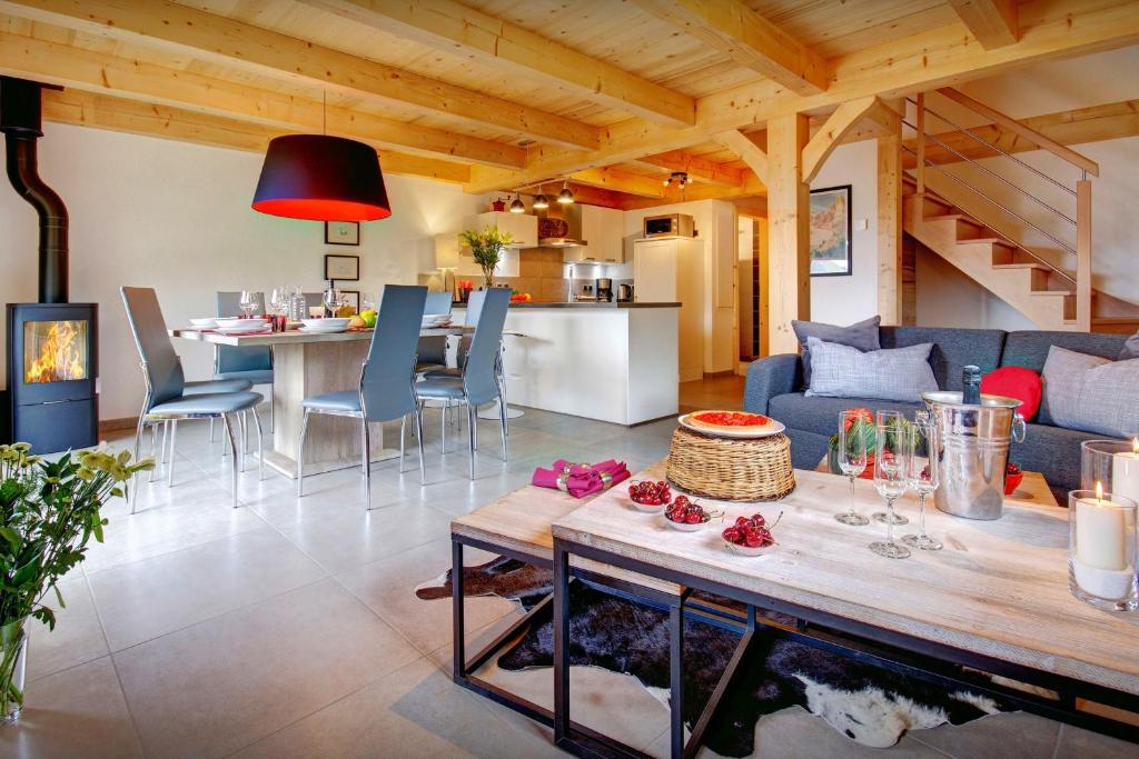 a living room with a couch and a table at Chalet de Paul et Marie - OVO Network in Manigod