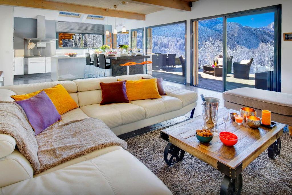 a living room with a couch and a table at Chalet de Rollon - OVO Network in Thônes