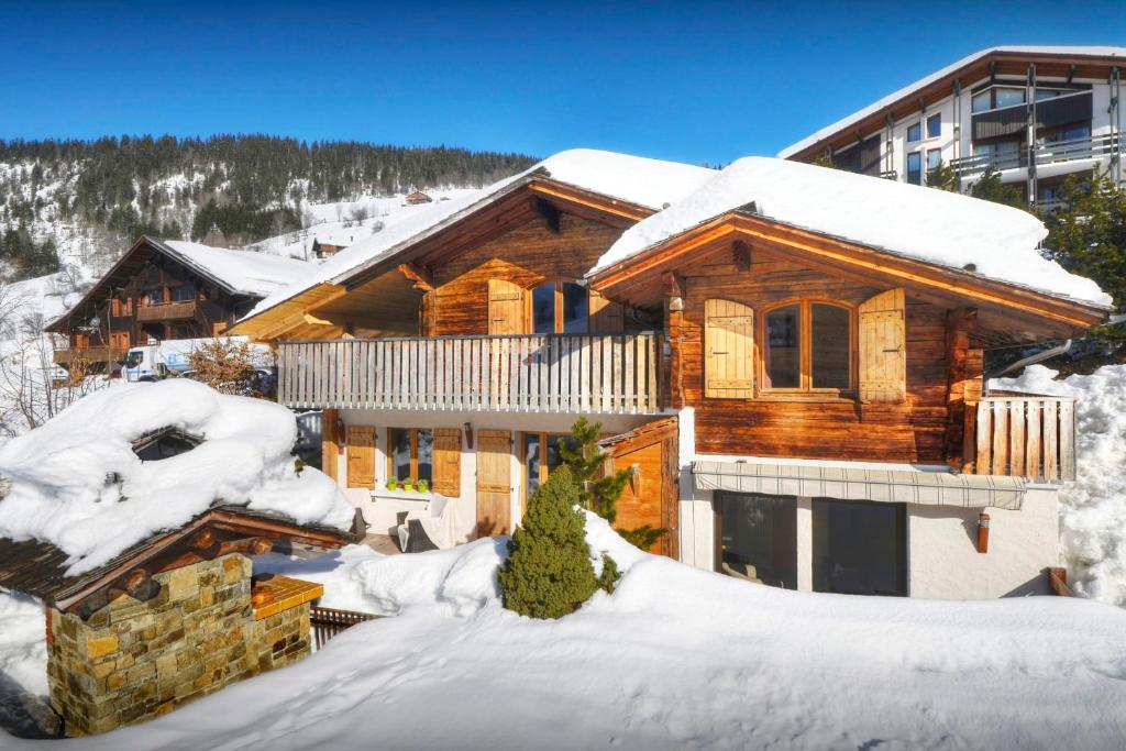 a log cabin in the snow with snow at Chalet Le Petit Mazot - OVO Network in La Clusaz