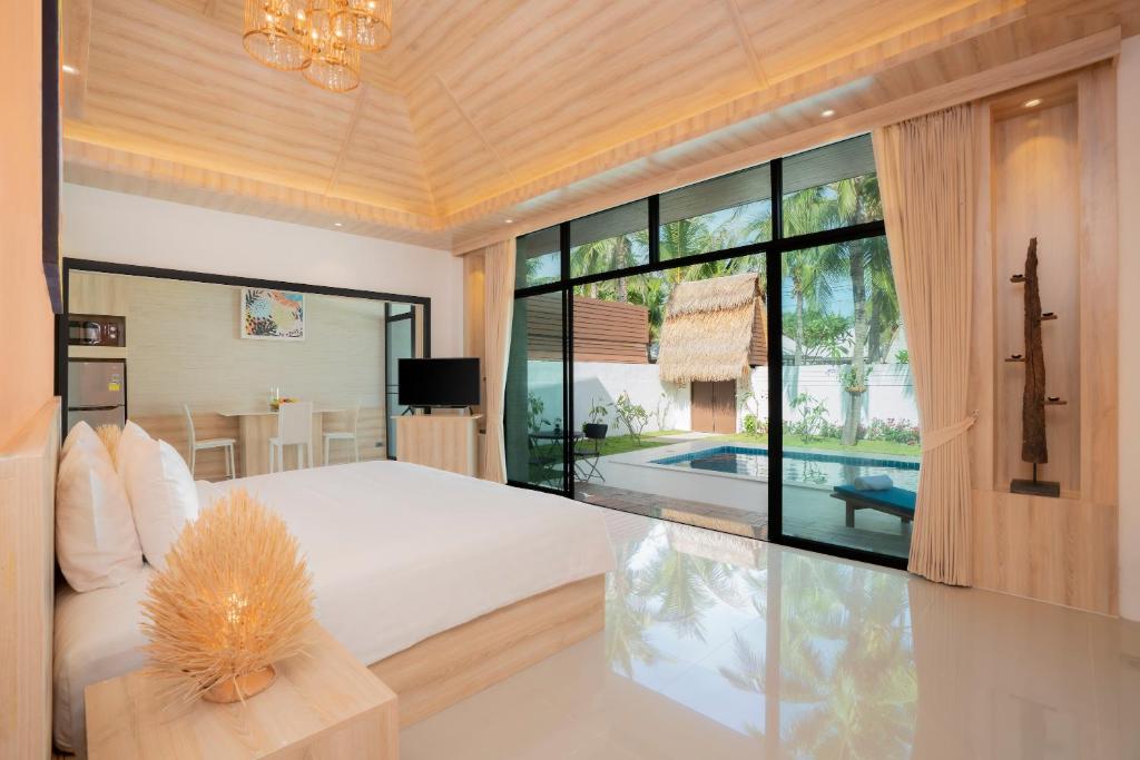 Postel nebo postele na pokoji v ubytování Dhevan Dara Resort & Spa Hua Hin - Pool Villa