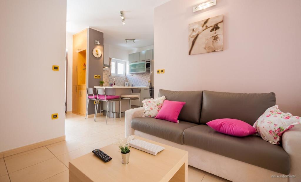a living room with a couch and a table at Aldo Apartments Center in Zadar