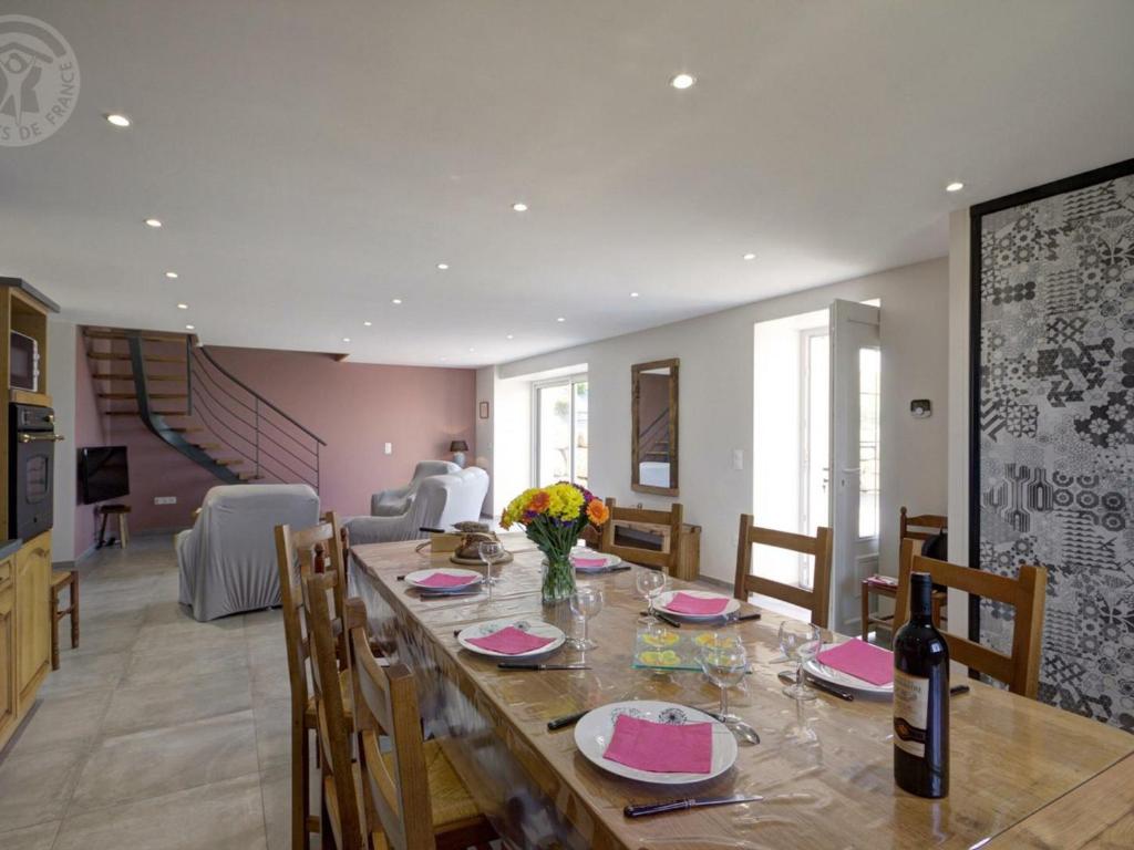 a dining room with a long wooden table with chairs at Gîte Panissières, 3 pièces, 8 personnes - FR-1-496-215 in Panissières