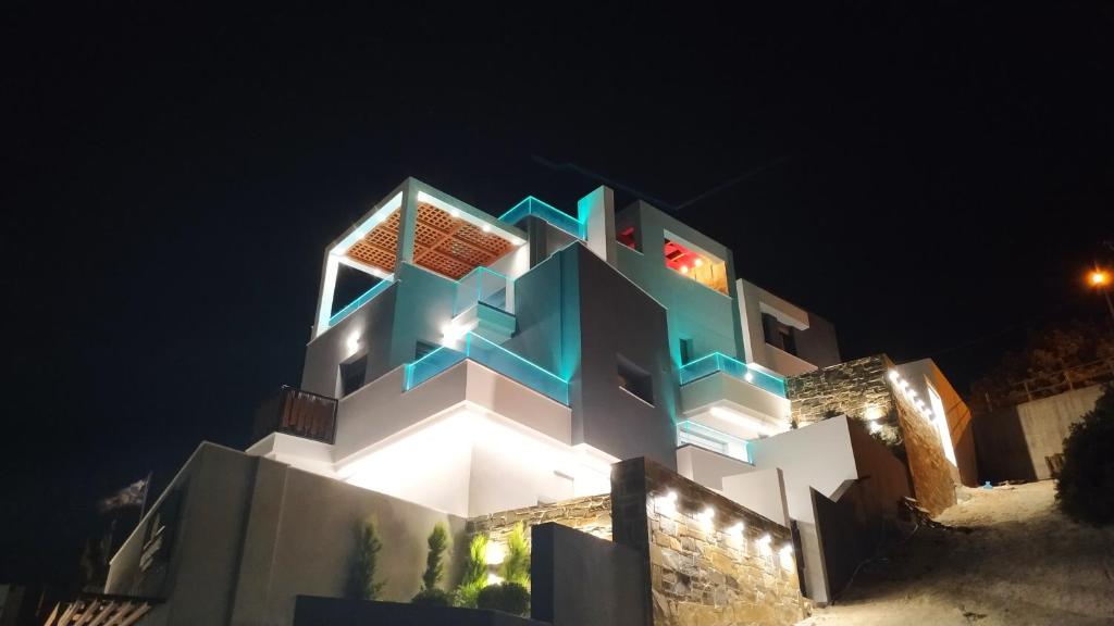 a building with a geometric design on it at night at Filia's Memories Apartments in Agios Nikolaos