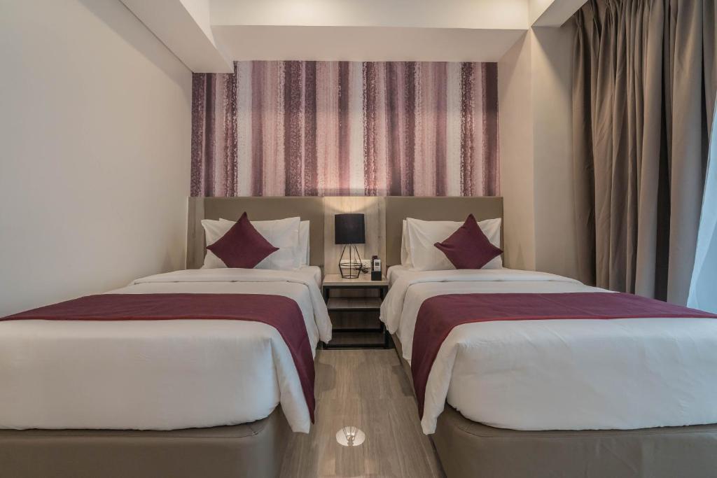Postel nebo postele na pokoji v ubytování Bayfront Hotel Cebu Capitol Site