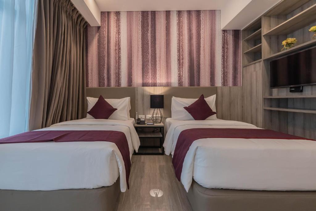 Postel nebo postele na pokoji v ubytování Bayfront Hotel Cebu Capitol Site