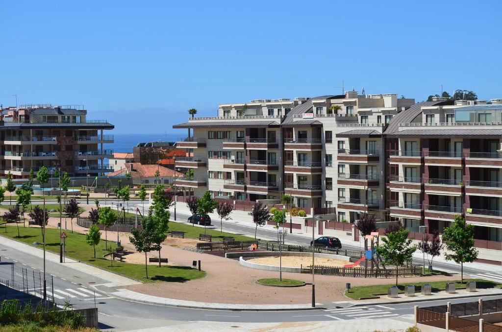 a city with tall apartment buildings and a park at FLATSELECT Decanelas in Portonovo