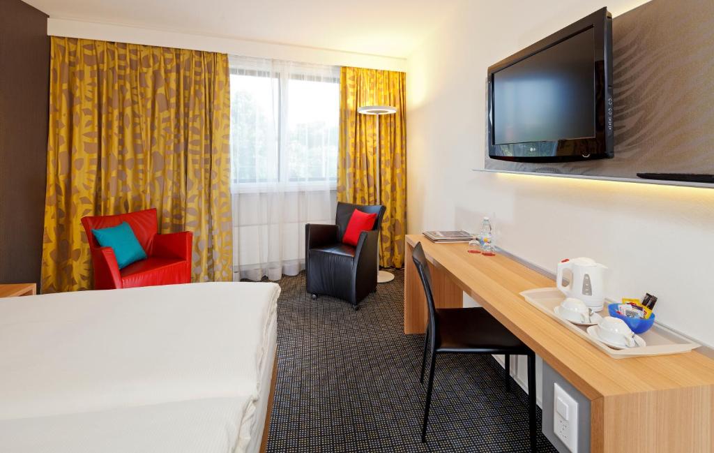 TV a/nebo společenská místnost v ubytování Hotel Metropol Basel