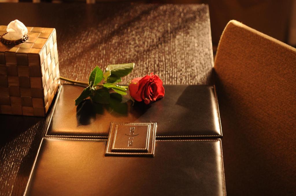 a red rose sitting on top of a seat at The Eclipse Boutique Suites in Abu Dhabi
