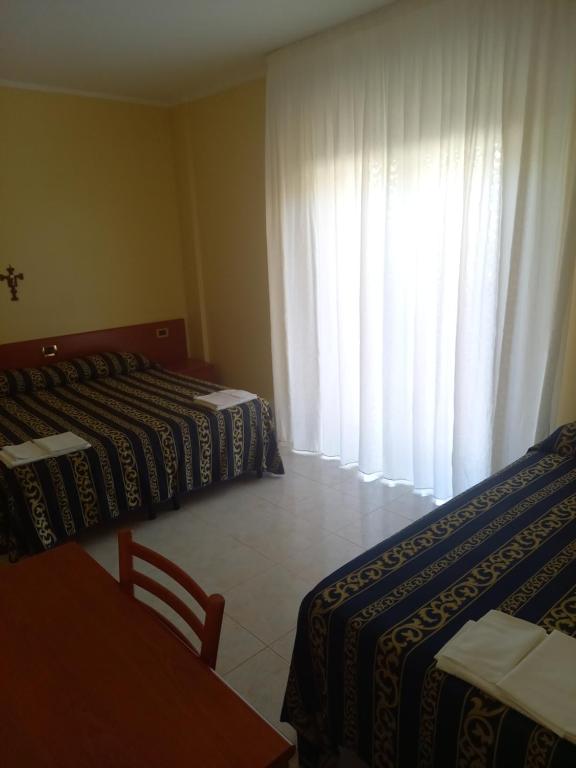 Postel nebo postele na pokoji v ubytování Hotel Il Chierichetto