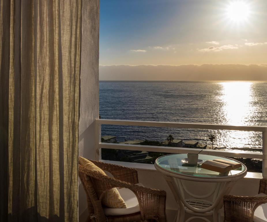 a room with a balcony with a view of the ocean at The Resthouse in Candelaria