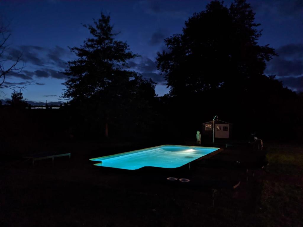 a swimming pool in a yard at night at Villa El tinganon in Llanes