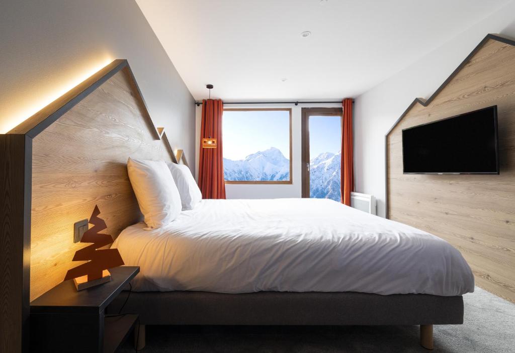 Postel nebo postele na pokoji v ubytování Hotel Base Camp Lodge - Les 2 Alpes