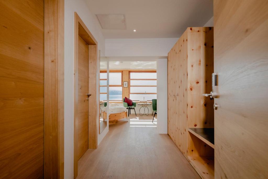 a hallway with a door and a room with a table at Polreich Bed&Breakfast in Hallstatt