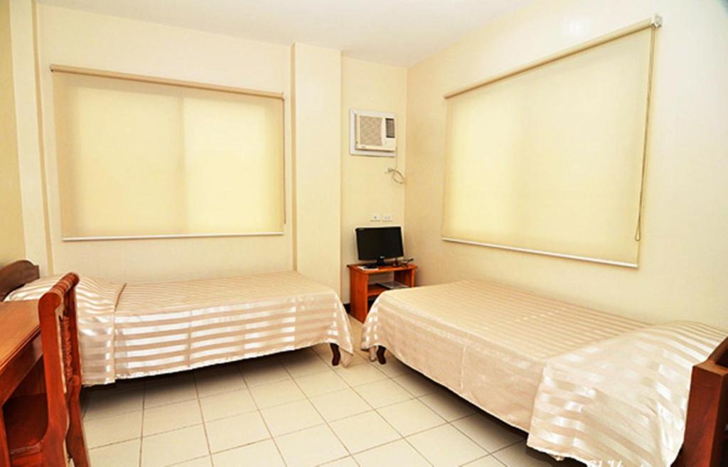Postel nebo postele na pokoji v ubytování El Haciendero Private Hotel