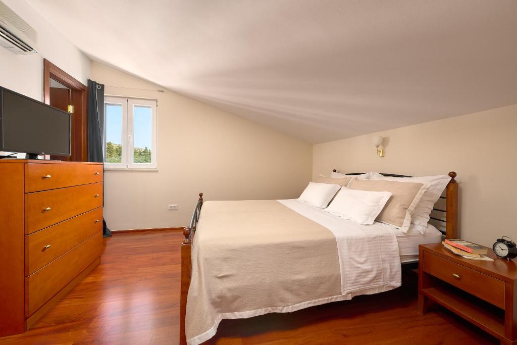 Postel nebo postele na pokoji v ubytování Hotel Villa Andrea