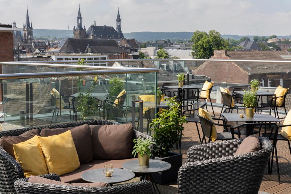 a living room filled with furniture and a patio at INNSiDE by Meliá Aachen in Aachen