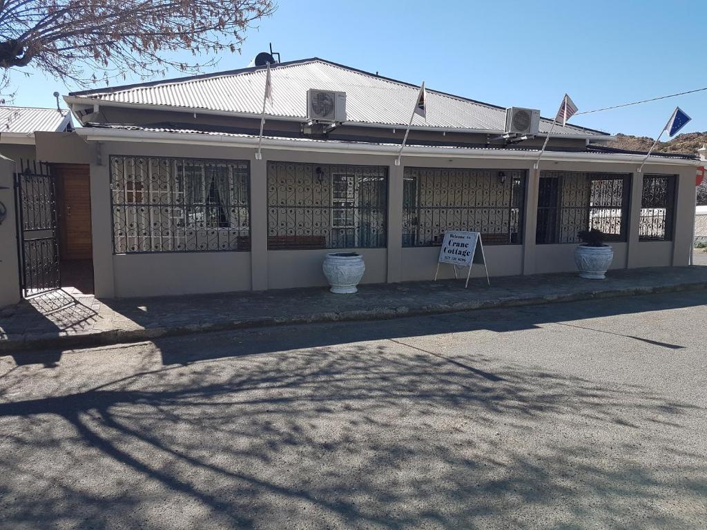 a building with a sign in front of it at Crane Cottage in Colesberg