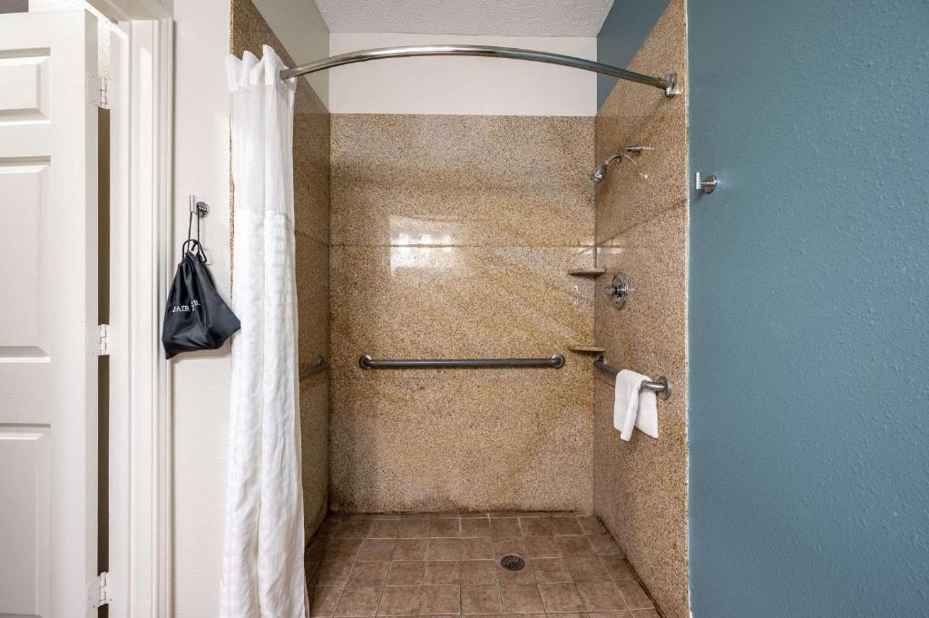a bathroom with a shower with a glass door at Sleep Inn & Suites in Birmingham